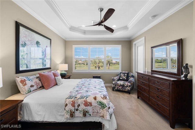 bedroom featuring ceiling fan, a raised ceiling, ornamental molding, and multiple windows