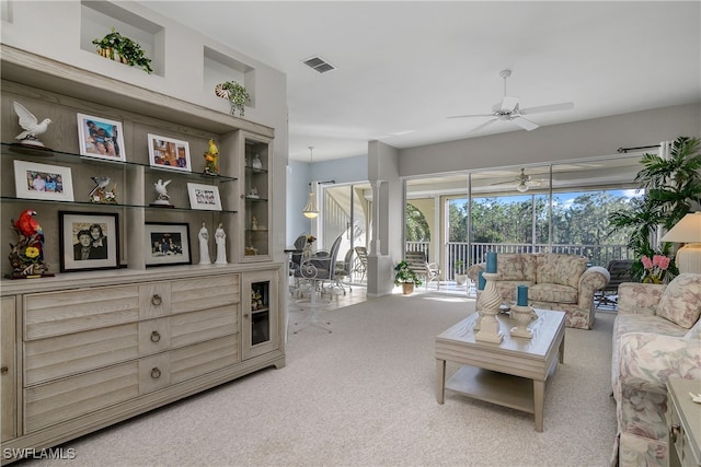 carpeted living room featuring ceiling fan