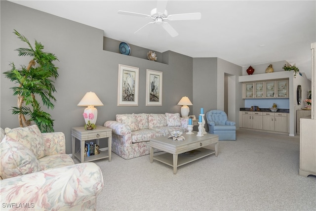 carpeted living room with ceiling fan