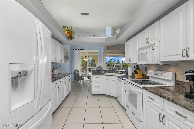 kitchen featuring sink, light tile patterned floors, dark stone countertops, white appliances, and white cabinets