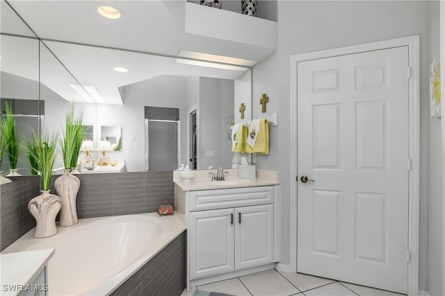 bathroom featuring tile patterned floors, vanity, and plus walk in shower