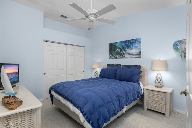 carpeted bedroom with ceiling fan and a closet