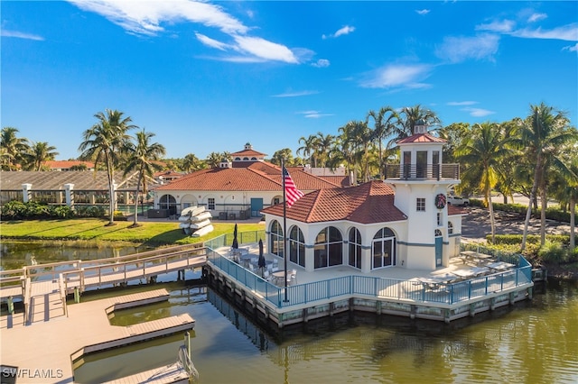 rear view of house with a yard and a water view