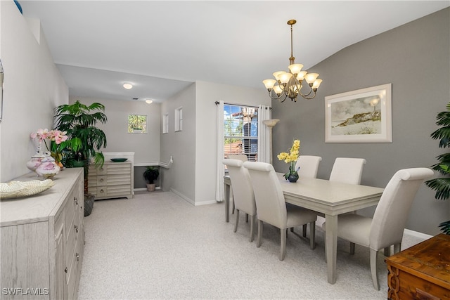 carpeted dining space featuring vaulted ceiling and a chandelier