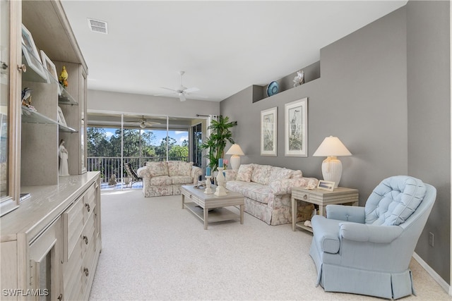 carpeted living room featuring ceiling fan