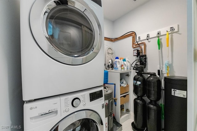 laundry room featuring stacked washer / drying machine