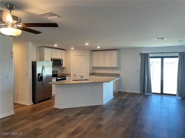 kitchen featuring a center island with sink, sink, dark hardwood / wood-style floors, appliances with stainless steel finishes, and white cabinetry