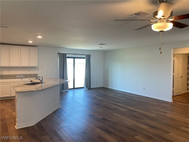 kitchen with white cabinets, dark hardwood / wood-style flooring, and sink