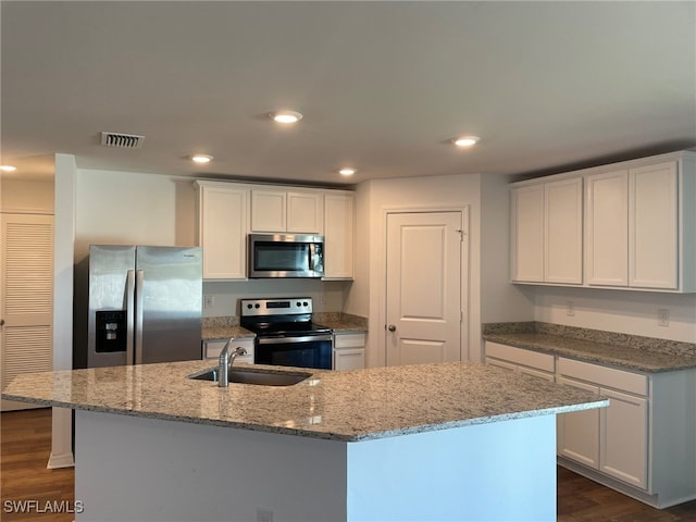 kitchen with white cabinetry, an island with sink, and appliances with stainless steel finishes