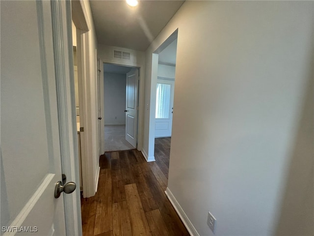 hallway with dark hardwood / wood-style floors