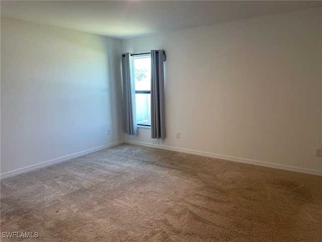 empty room featuring light colored carpet