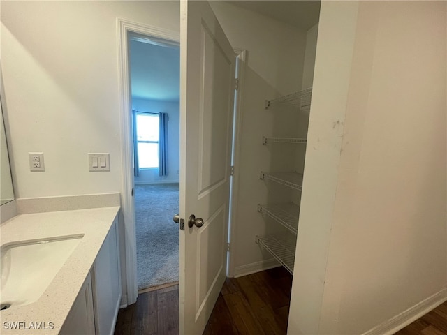 bathroom with vanity and hardwood / wood-style flooring