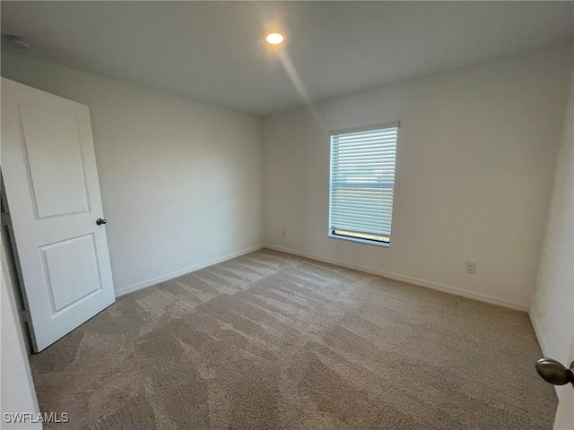 spare room featuring carpet