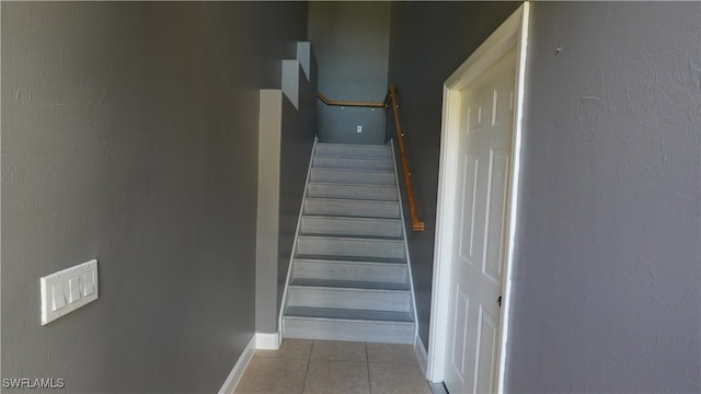 staircase with tile patterned flooring