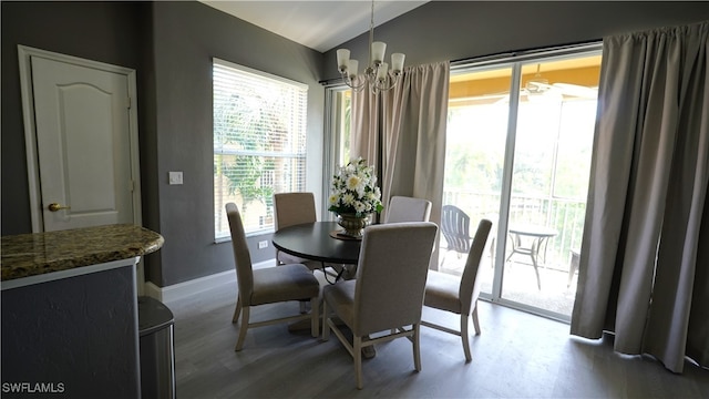 dining space featuring hardwood / wood-style flooring and an inviting chandelier