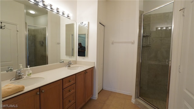 bathroom featuring tile patterned flooring, vanity, and walk in shower