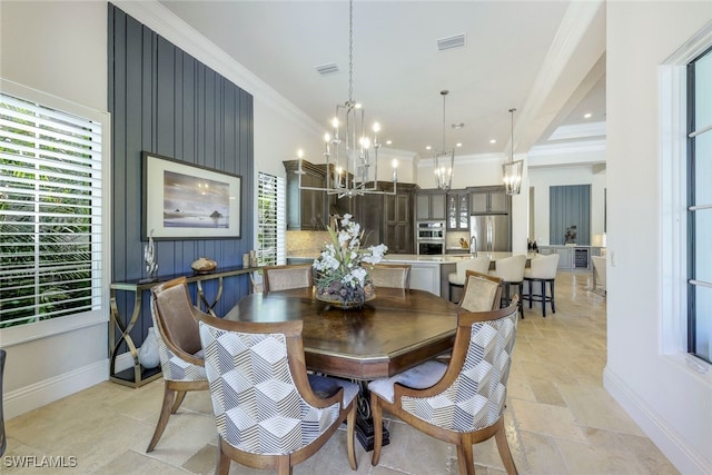 dining area featuring an inviting chandelier and ornamental molding