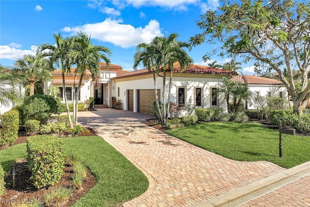 mediterranean / spanish house featuring a front lawn and a garage