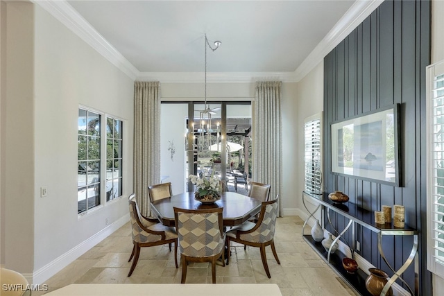 dining space with ornamental molding, a wealth of natural light, and a chandelier