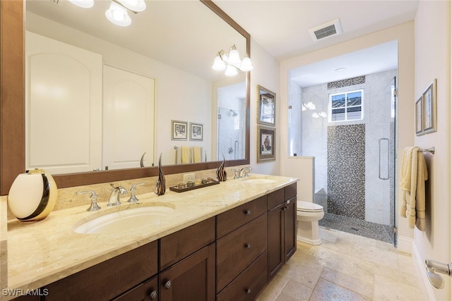 bathroom featuring toilet, vanity, an enclosed shower, and an inviting chandelier