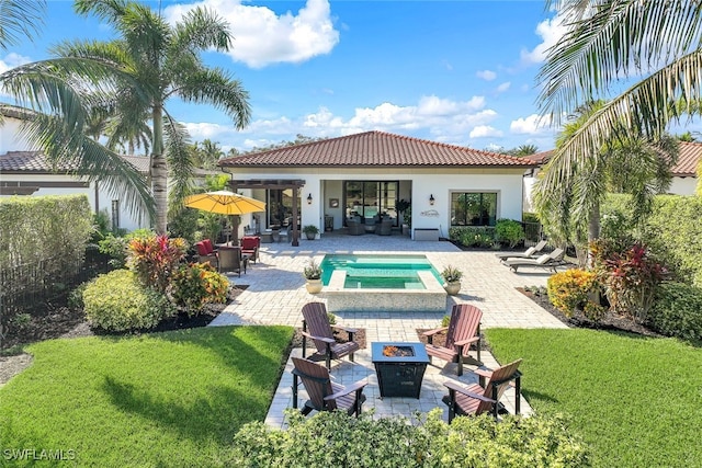 rear view of house featuring a lawn, a swimming pool with hot tub, a patio area, and an outdoor living space with a fire pit