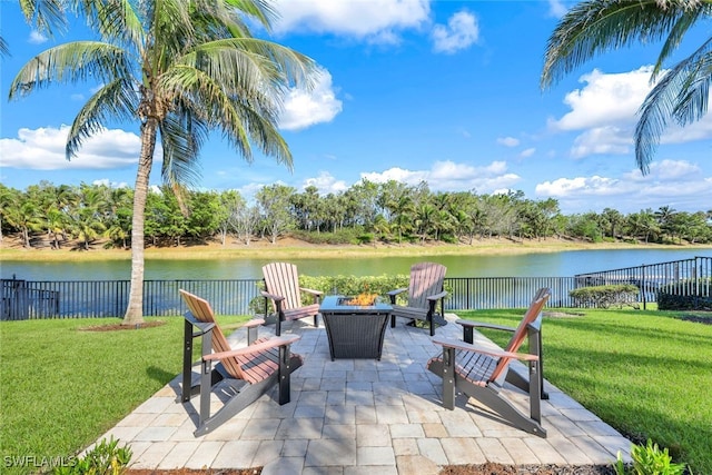 view of patio with a water view and an outdoor fire pit