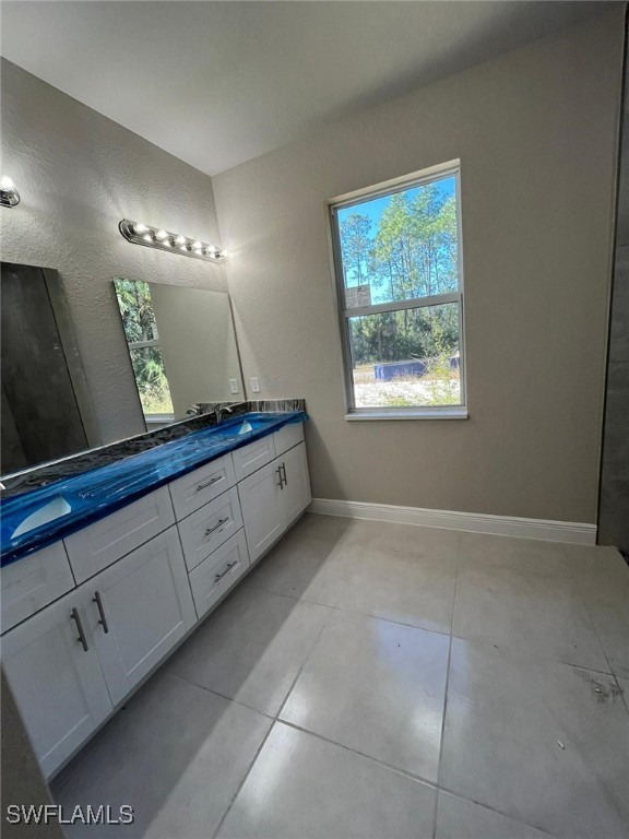 bathroom with tile patterned floors and vanity