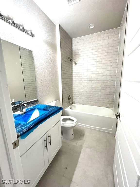 full bathroom featuring vanity, toilet, and tiled shower / bath