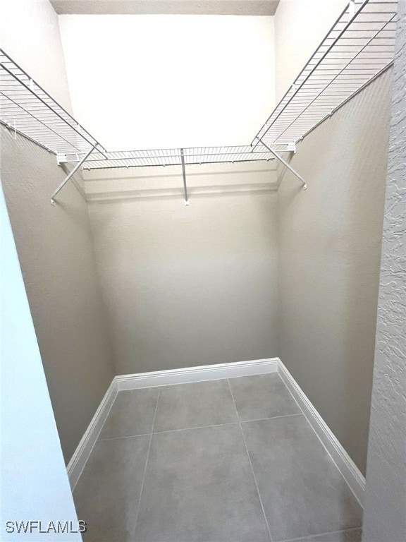 walk in closet featuring tile patterned flooring