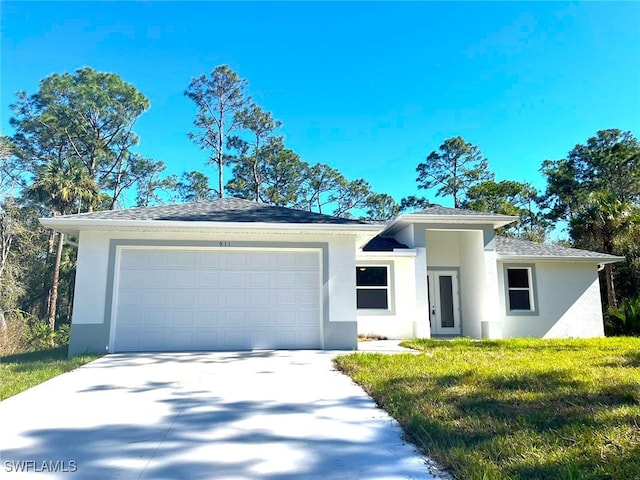 view of front of house featuring a garage and a front yard