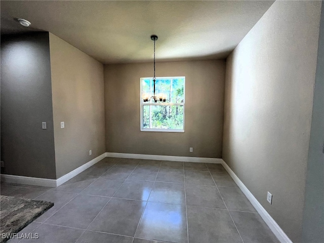 unfurnished dining area featuring tile patterned floors and a notable chandelier