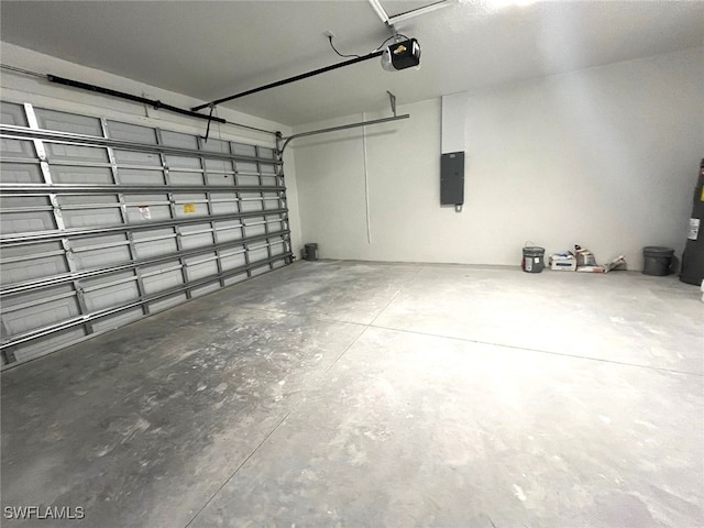 garage featuring electric panel and a garage door opener