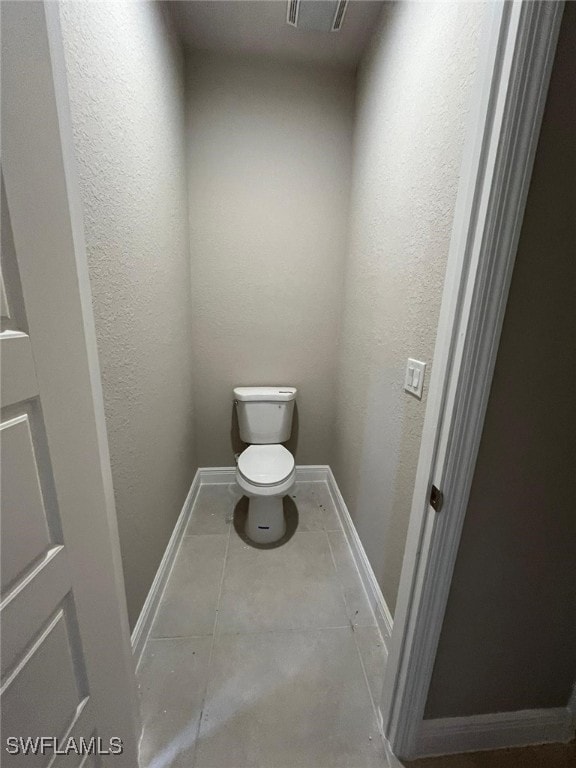 bathroom with tile patterned flooring and toilet