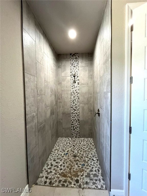 bathroom with a tile shower