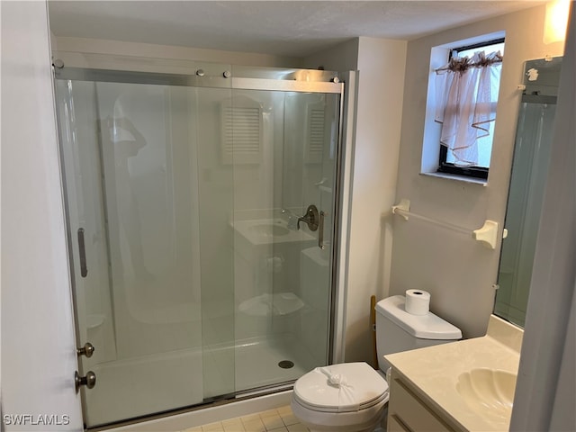 bathroom with vanity, a shower with door, tile patterned floors, toilet, and a textured ceiling