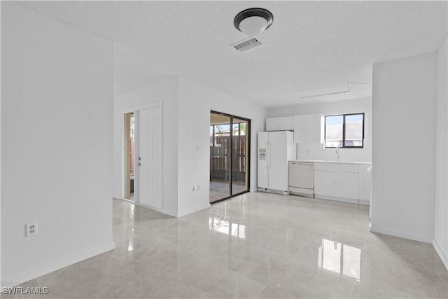 empty room featuring sink and a textured ceiling