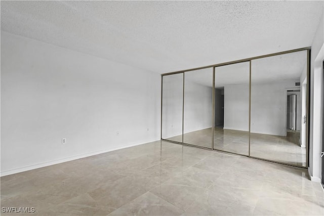 5260 Cedarbend Dr SW Unit 4, Fort Myers, FL 33919 - unfurnished bedroom featuring a textured ceiling and a closet