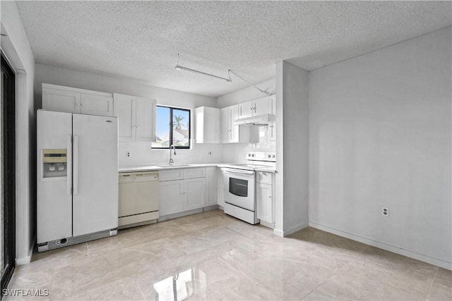 kitchen with a textured ceiling, sink, white cabinets, and white appliances