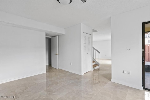 spare room featuring a textured ceiling