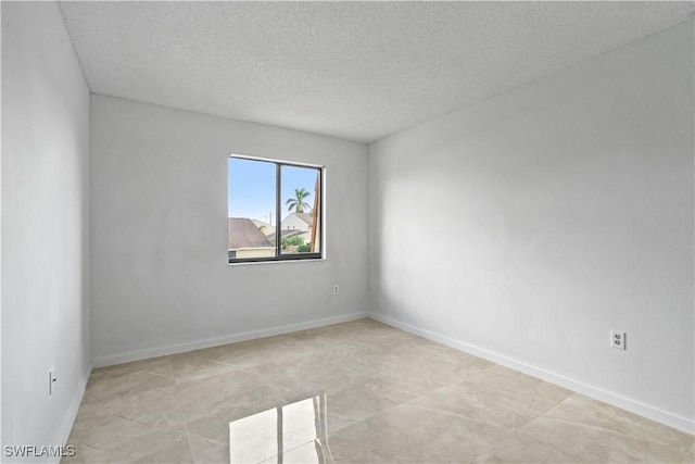 spare room with a textured ceiling