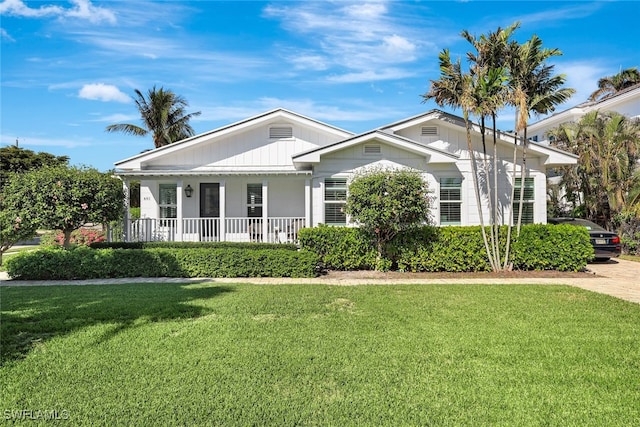 view of front of property with a front yard and a porch