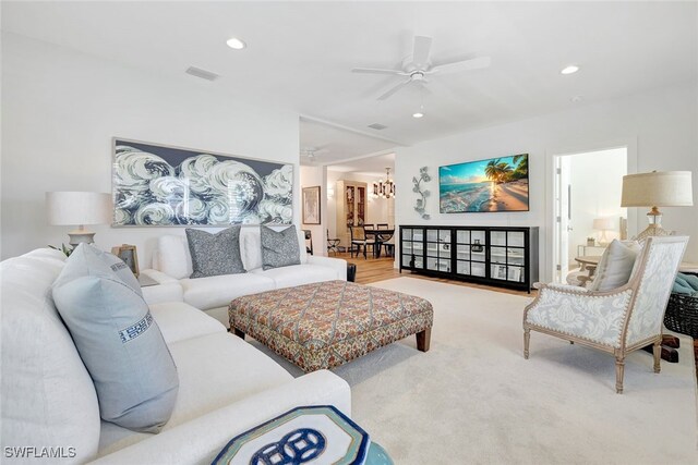 living room featuring ceiling fan and carpet