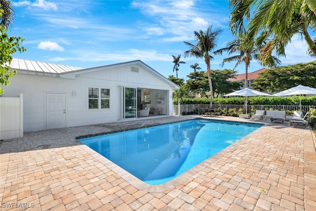 view of pool featuring outdoor lounge area and a patio