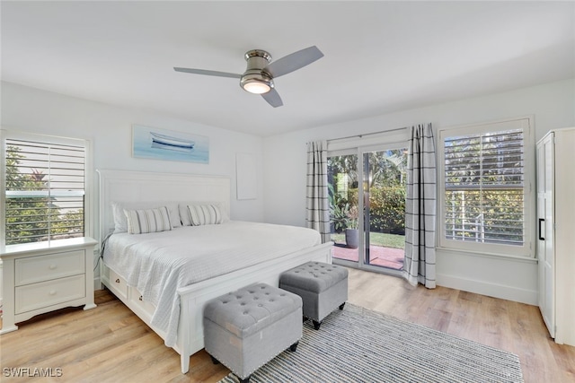 bedroom featuring multiple windows, ceiling fan, light hardwood / wood-style flooring, and access to exterior