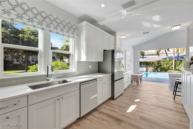 kitchen featuring dishwasher, light hardwood / wood-style flooring, white cabinetry, and sink