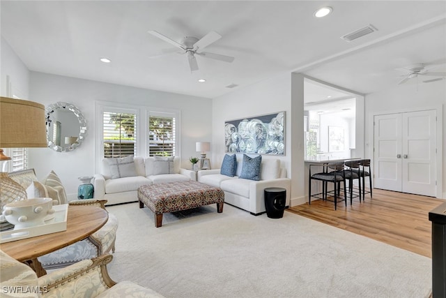 living room with hardwood / wood-style flooring and ceiling fan