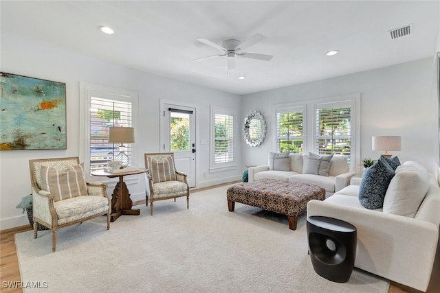 living room featuring ceiling fan and light wood-type flooring