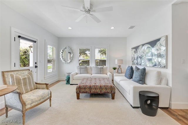 living room with ceiling fan and light wood-type flooring