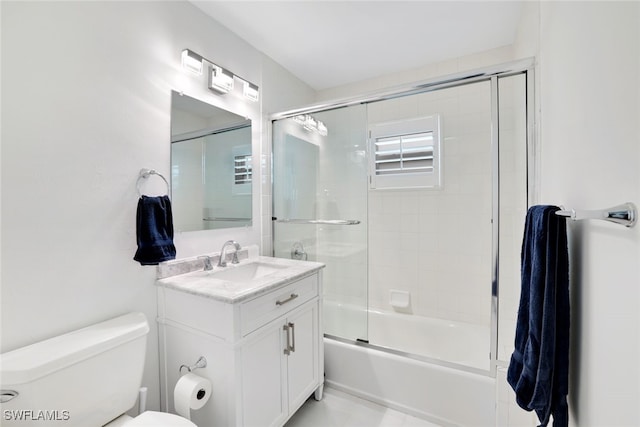 full bathroom with vanity, toilet, and enclosed tub / shower combo