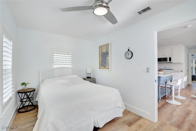 bedroom featuring ceiling fan and light hardwood / wood-style flooring